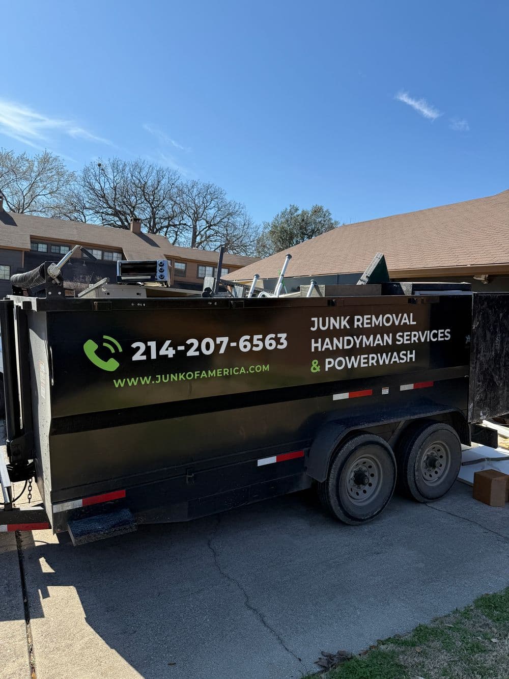 Junk removal trailer with contact details, handyman services, and power washing information.